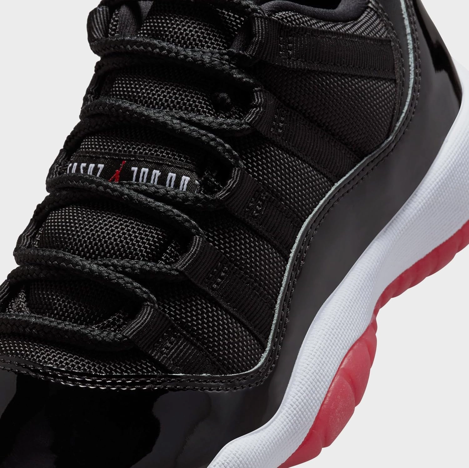 Air Jordan 11 Retro Low Bred Grade School Lifestyle Shoes (Black/Red/White)